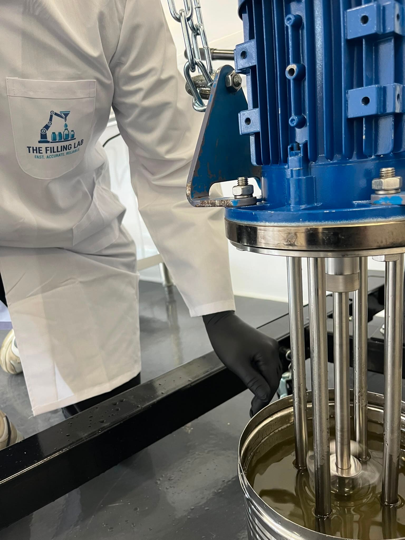 High-shear mixer operator in The Filling Lab coat - Preview for kitchen-to-plant scale-up article.