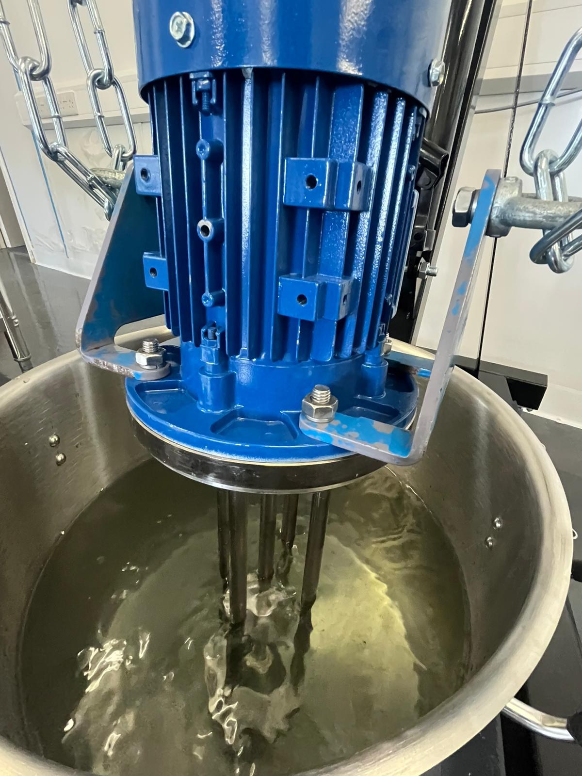 Blue transfer pump on stainless pipework - Moving blended bulk from vessel toward the fill line.